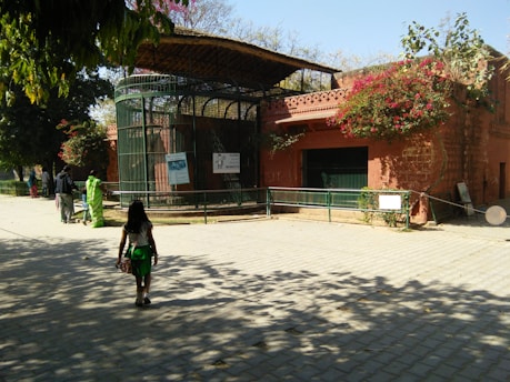 Parents and children walking through the school garden and classrooms during a sunny day tour.