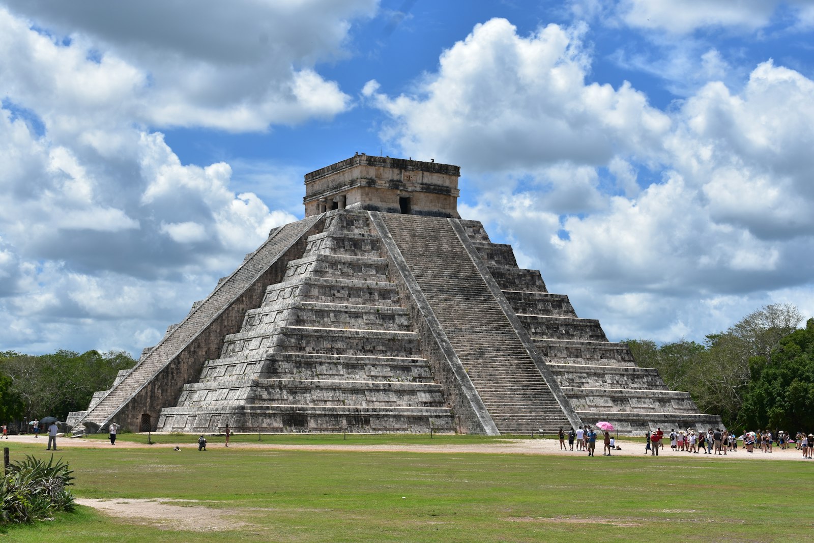 El Castillo pyramid at Chichén Itzá under a blue sky with white clouds