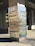 A tall, rectangular signpost displays the address 750 Town & Country Blvd and lists several company logos including Microsoft, Argus Software, Altus Group, MISA, Mercantil Commercebank, Southcross Energy, and Moody Rambin. The signpost is set against a modern office building with large windows and tiling on the ground.