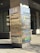 A tall, rectangular signpost displays the address 750 Town & Country Blvd and lists several company logos including Microsoft, Argus Software, Altus Group, MISA, Mercantil Commercebank, Southcross Energy, and Moody Rambin. The signpost is set against a modern office building with large windows and tiling on the ground.