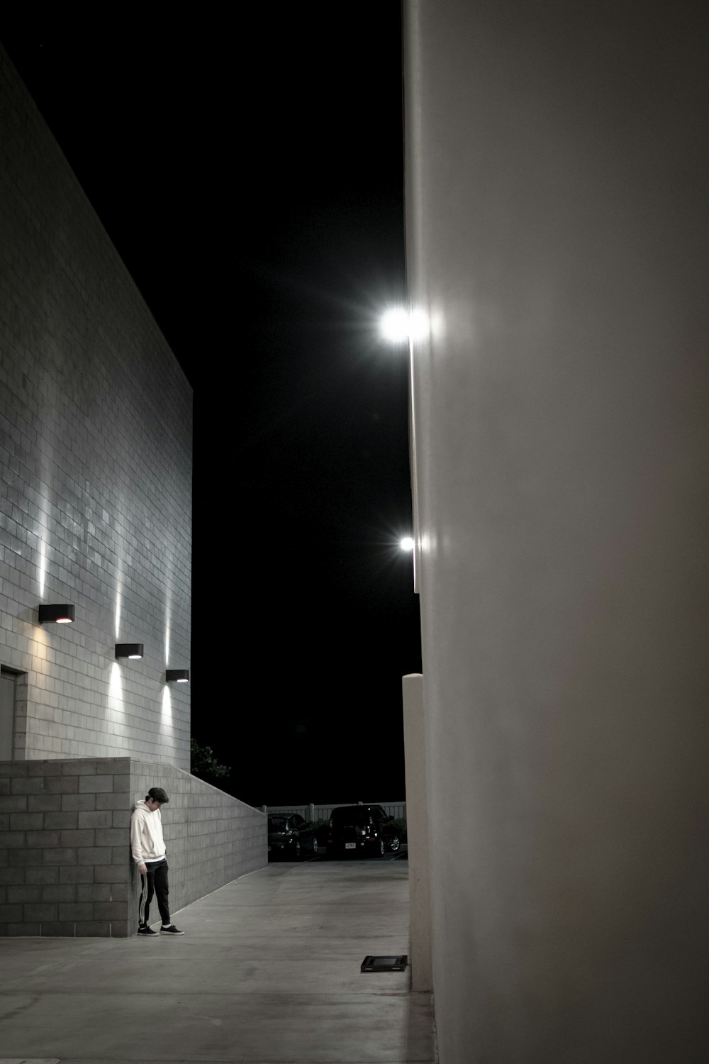 man leaning on concrete wall