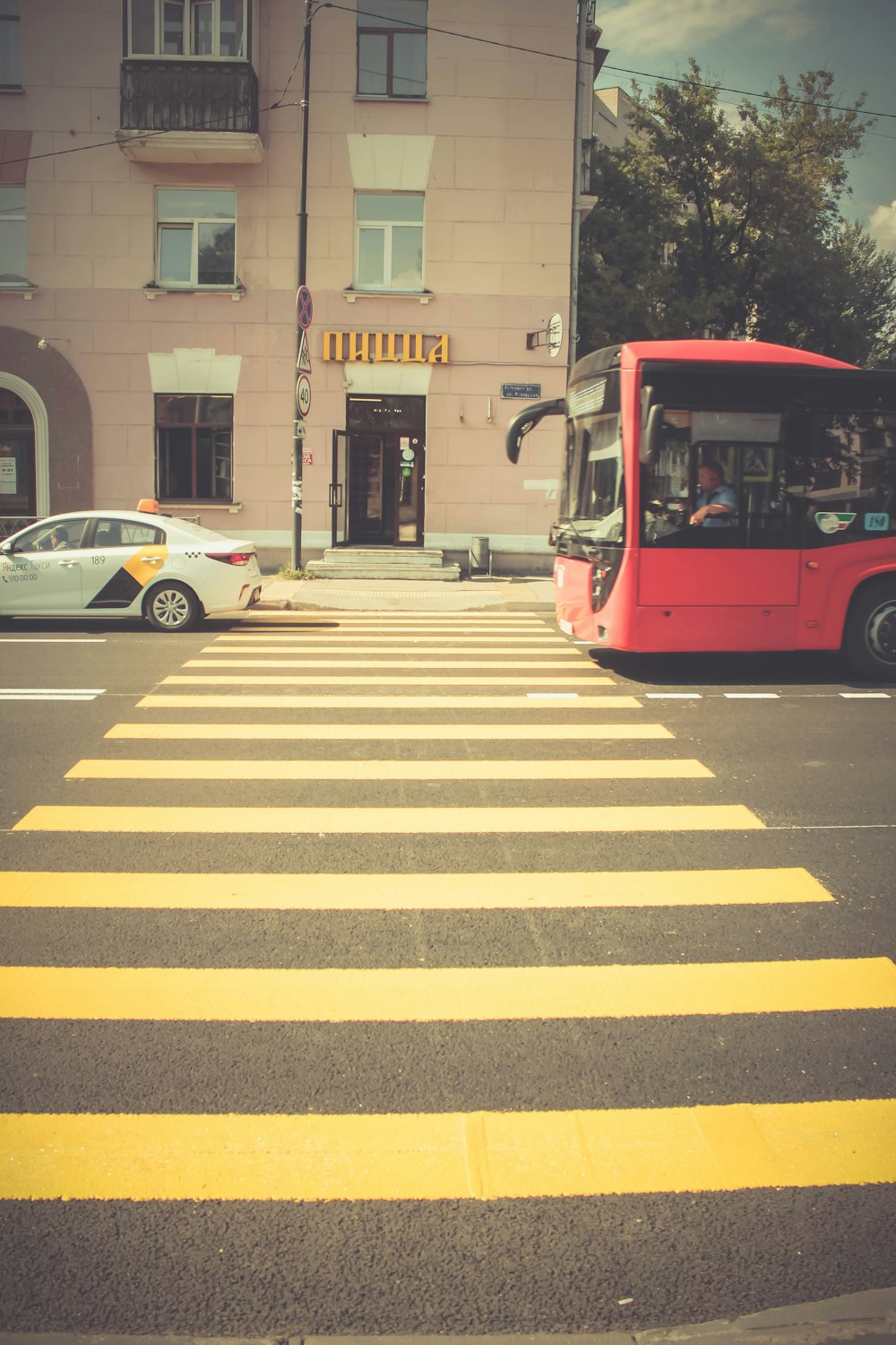 red bus near pedestrian lane