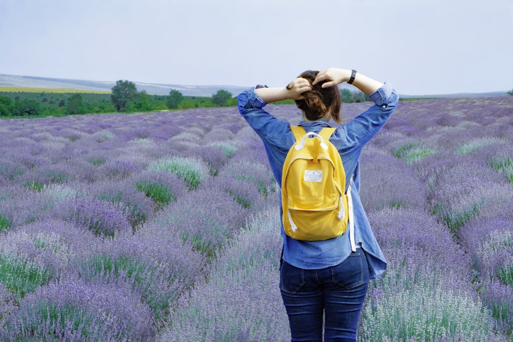 woman standing in front of flowers