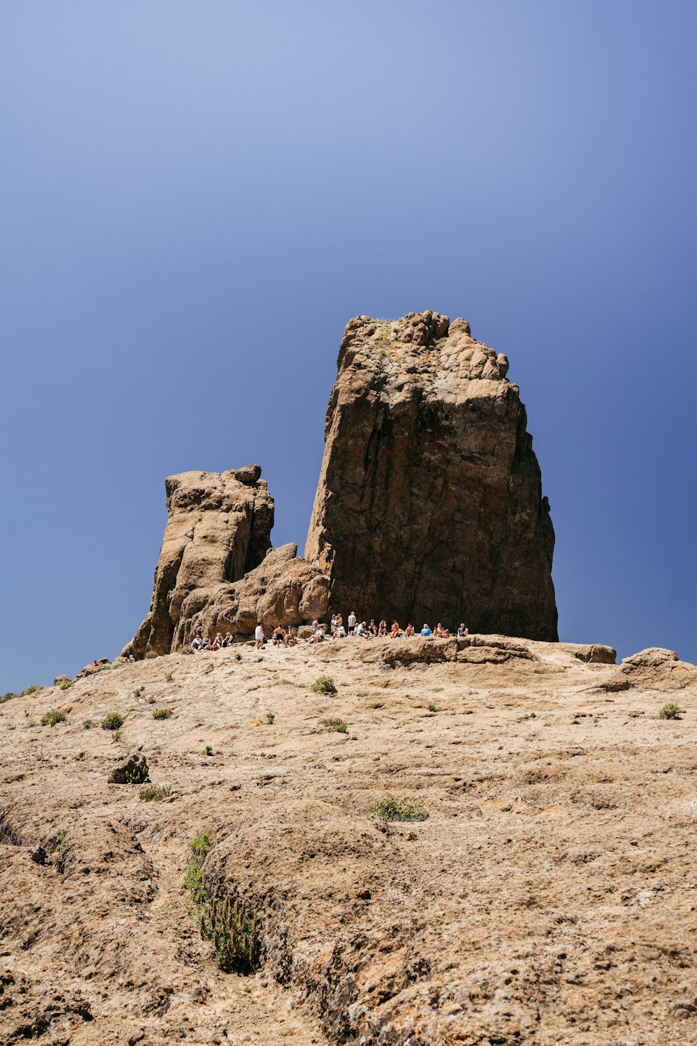 people near rock on mountain