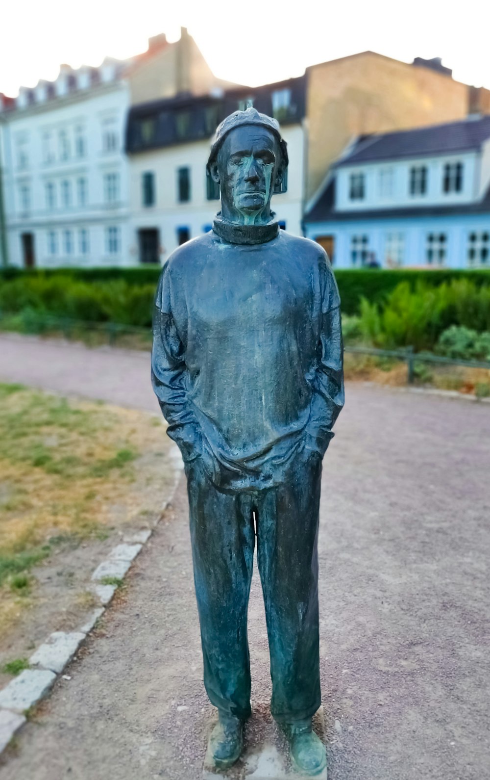 black ceramic figurine of man with hands on pockets