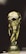 A golden trophy featuring a globe supported by two human figures, intricately designed with a shining metallic surface.