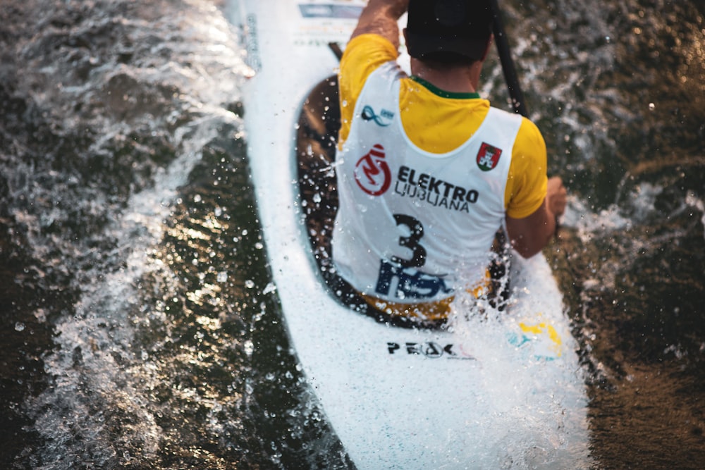 man on kayak against waves