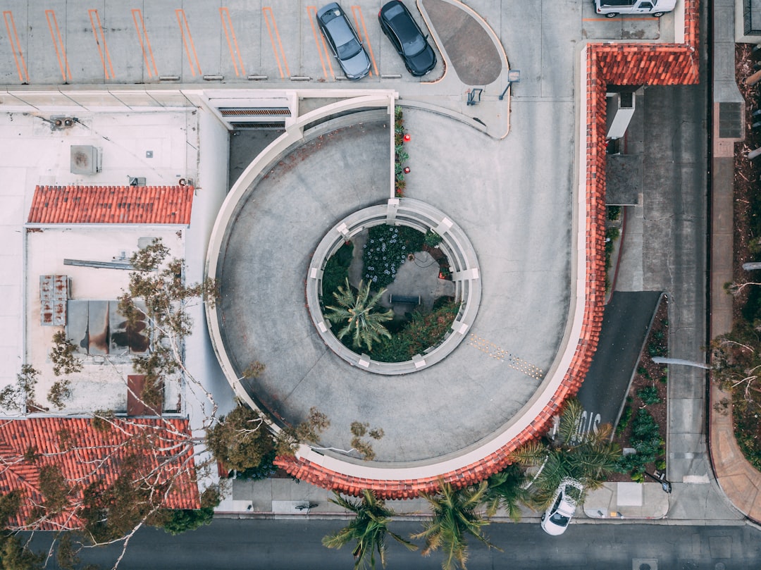 bird's-eye view of two cars parked on building roof