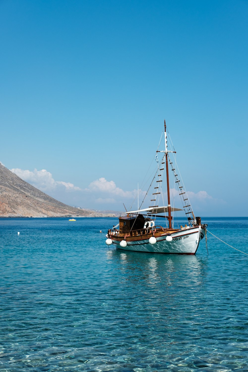 white and brown boat on body of water during daytime