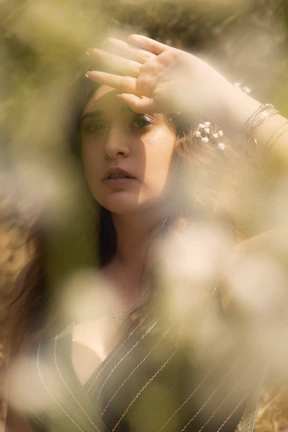 Woman wearing subtle silver jewelry, captured in natural light with a soft focus.