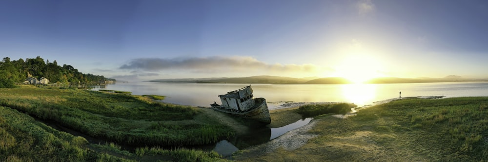 panoramic photography of green field and blue sea