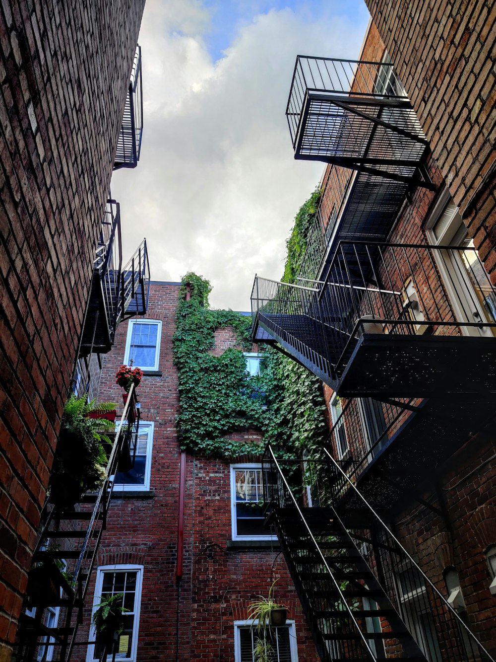 maroon building under cloudy sky