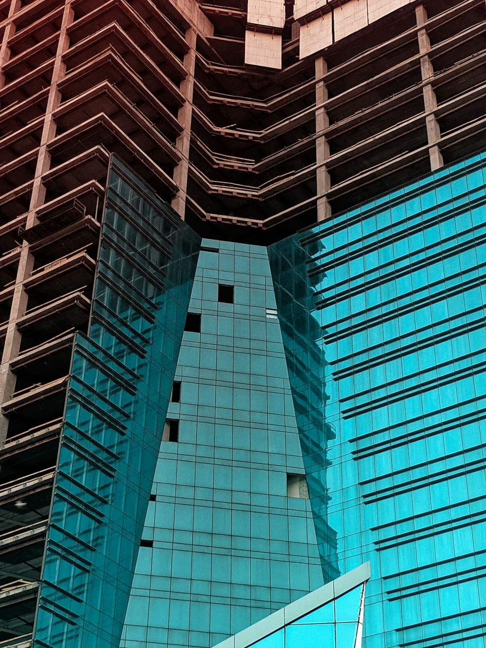 low-angle photography of blue and brown glass high-rise building