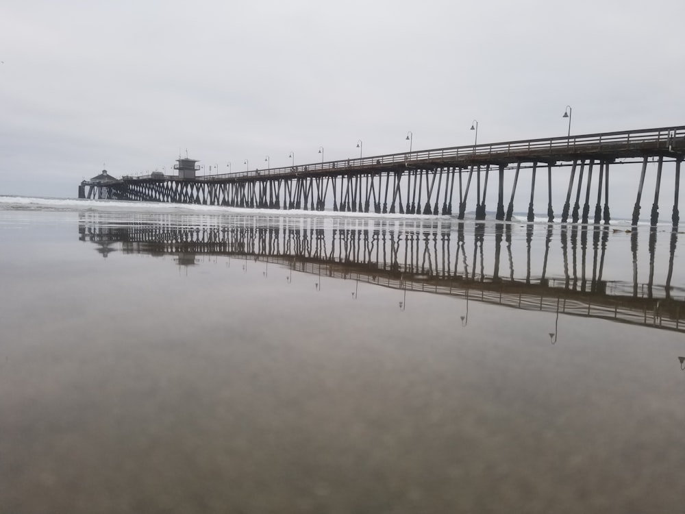 black bridge under cloudy sky during daytime