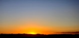 A vibrant sunset over a mountain range, representing new beginnings.