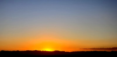 A vibrant sunset over a mountain range, representing new beginnings.