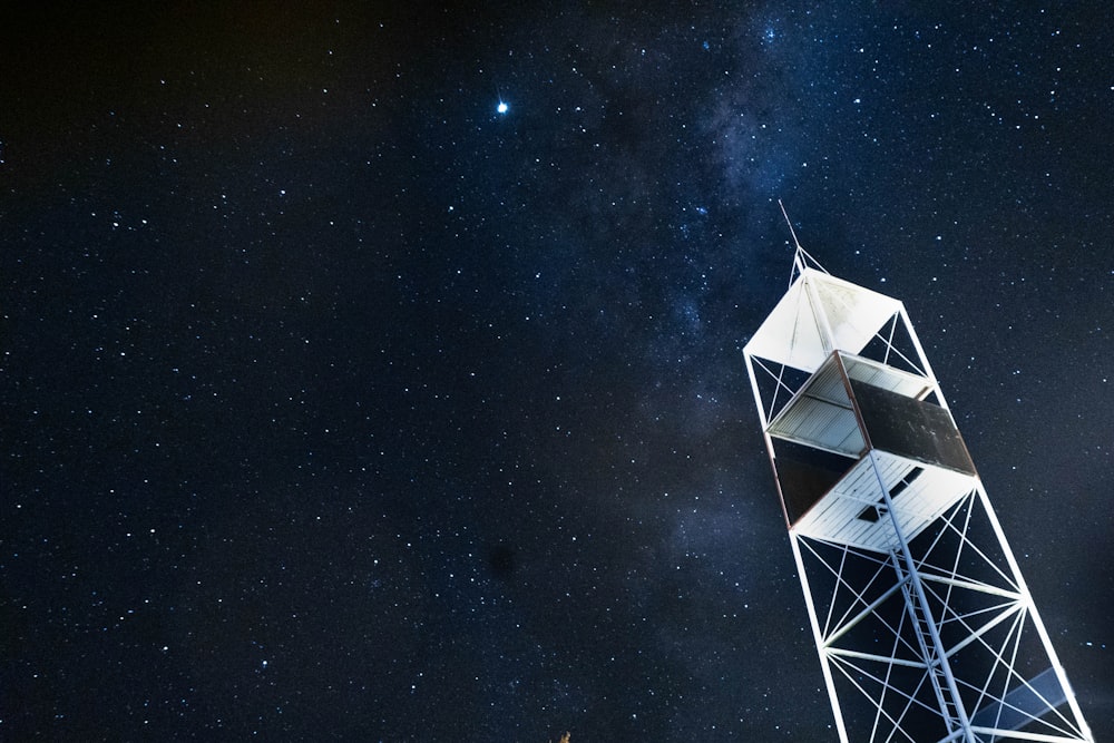 low-angle photography of electrical tower under starry sky during nighttime