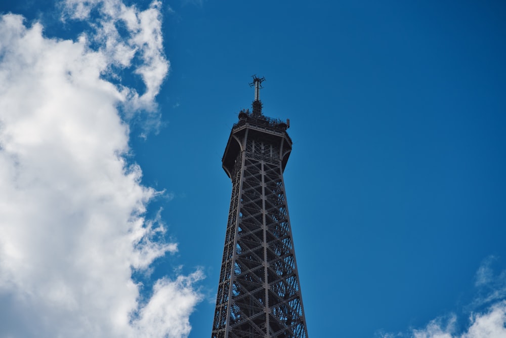 gray tower under blue and cloudy sky