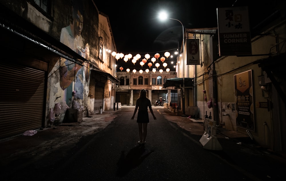 person standing on road during nighttime