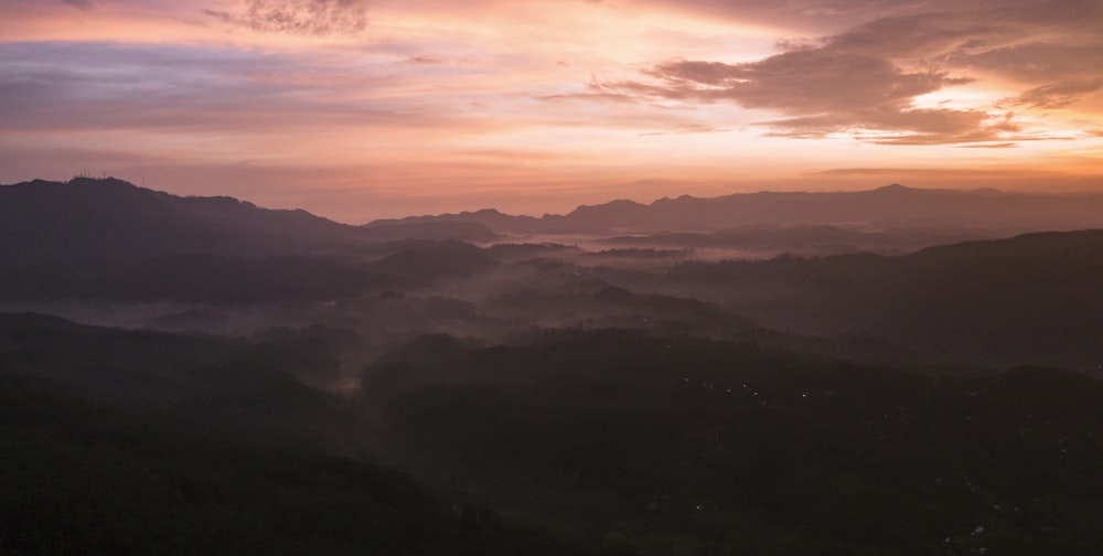 mountains under orange sky