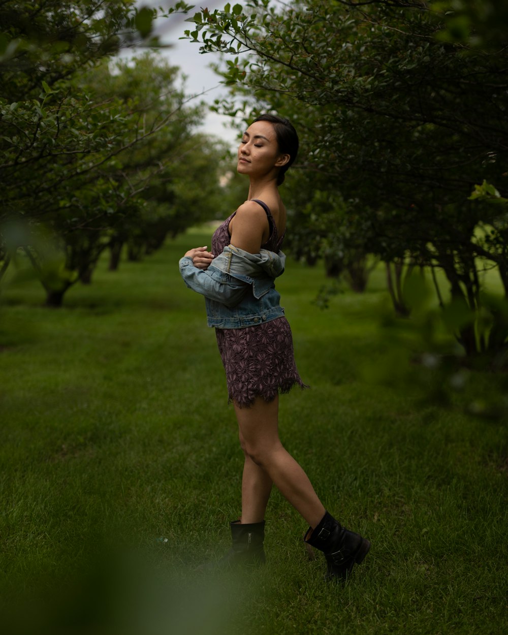 woman standing and about to walk in green feild