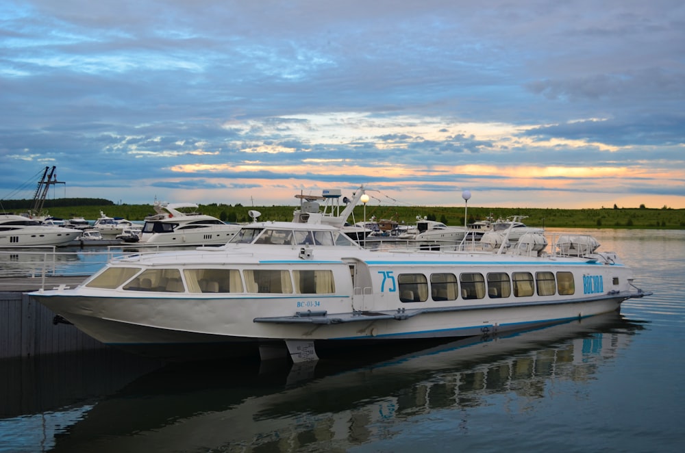 white boat on calm body of water