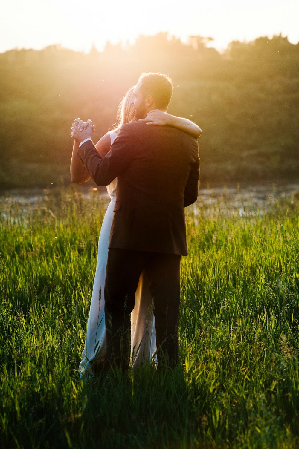 man and woman dancing on green grass field
