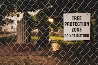 Tree Protection Zone board hanging on chain link fence