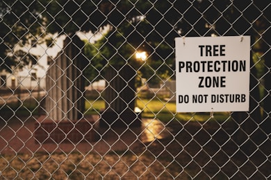 Tree Protection Zone board hanging on chain link fence