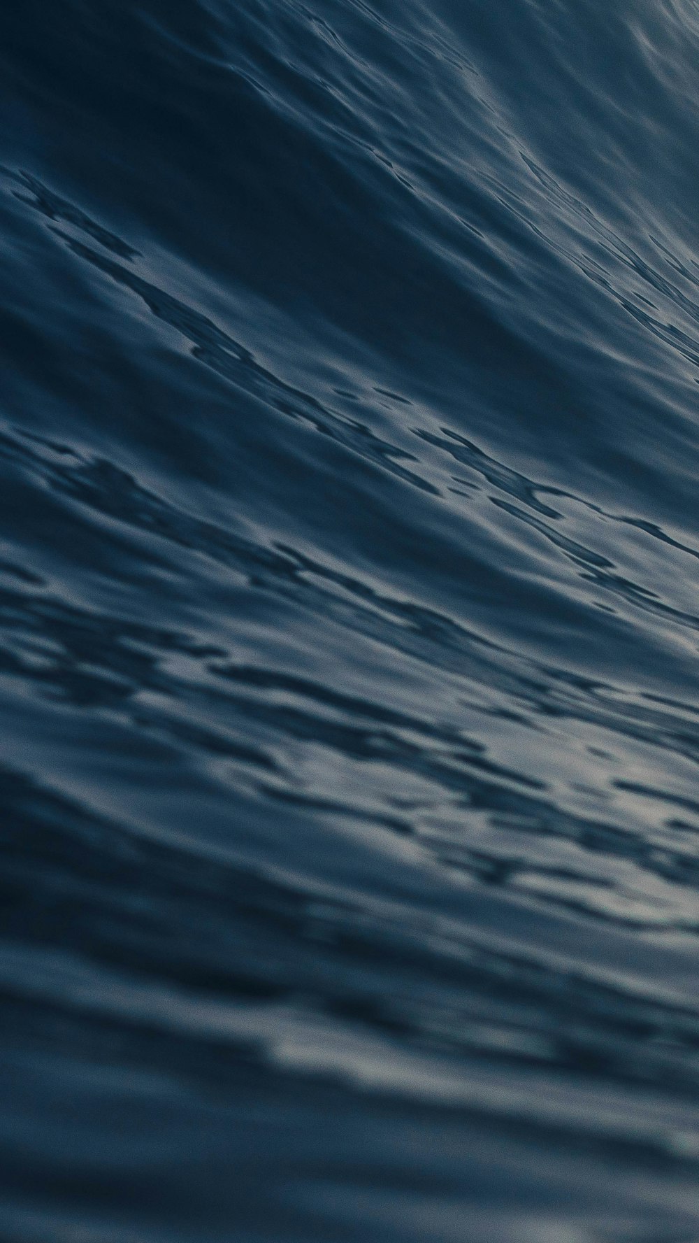 a person riding a surfboard on a wave in the ocean