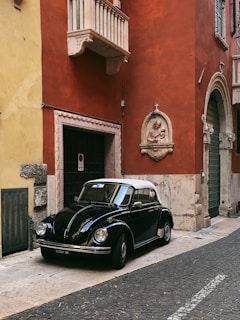 black Volkswagen Beetle near building