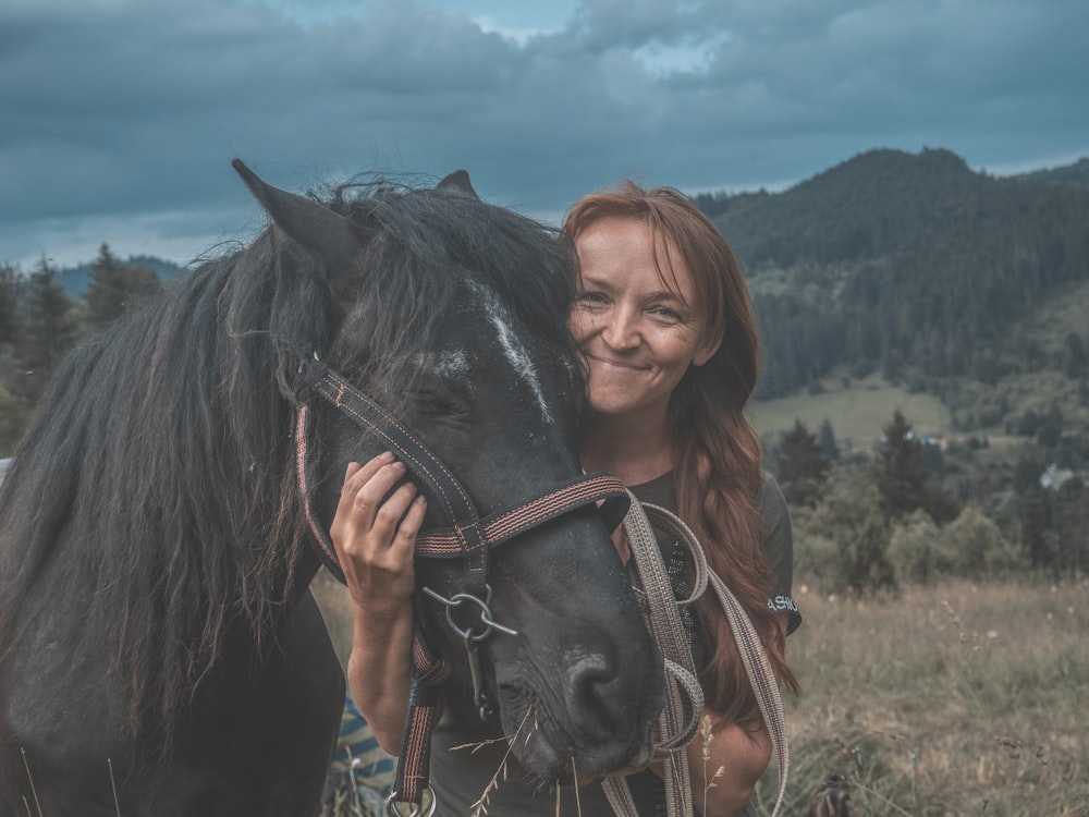 woman holding horse