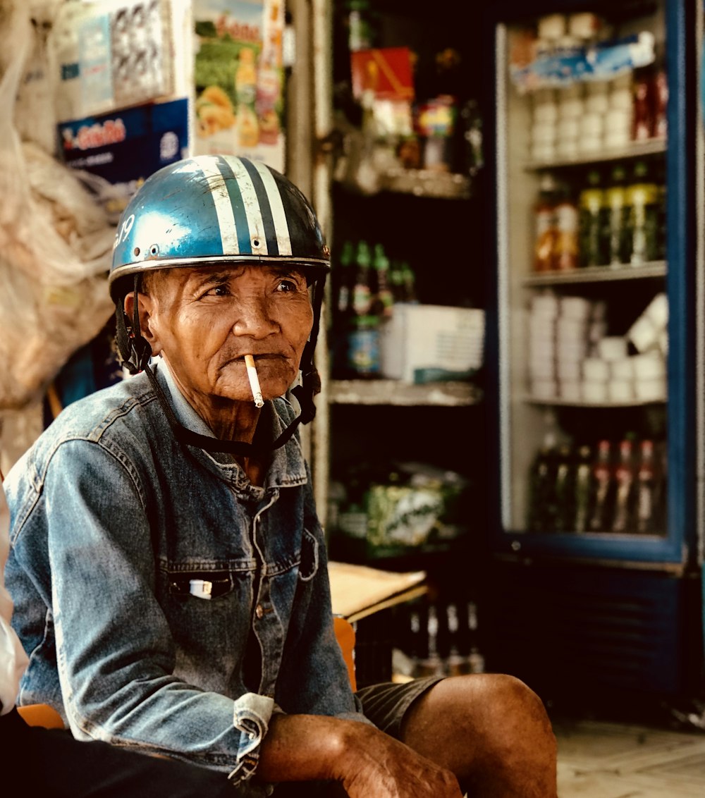 man smoking while wearing helmet