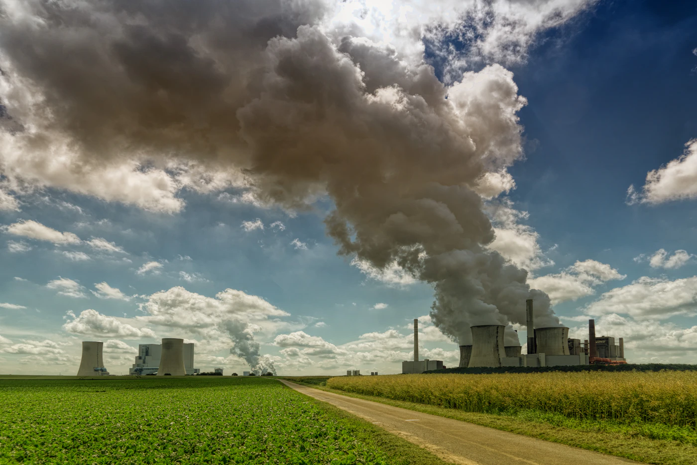 An industrial site with chimneys emitting smoke