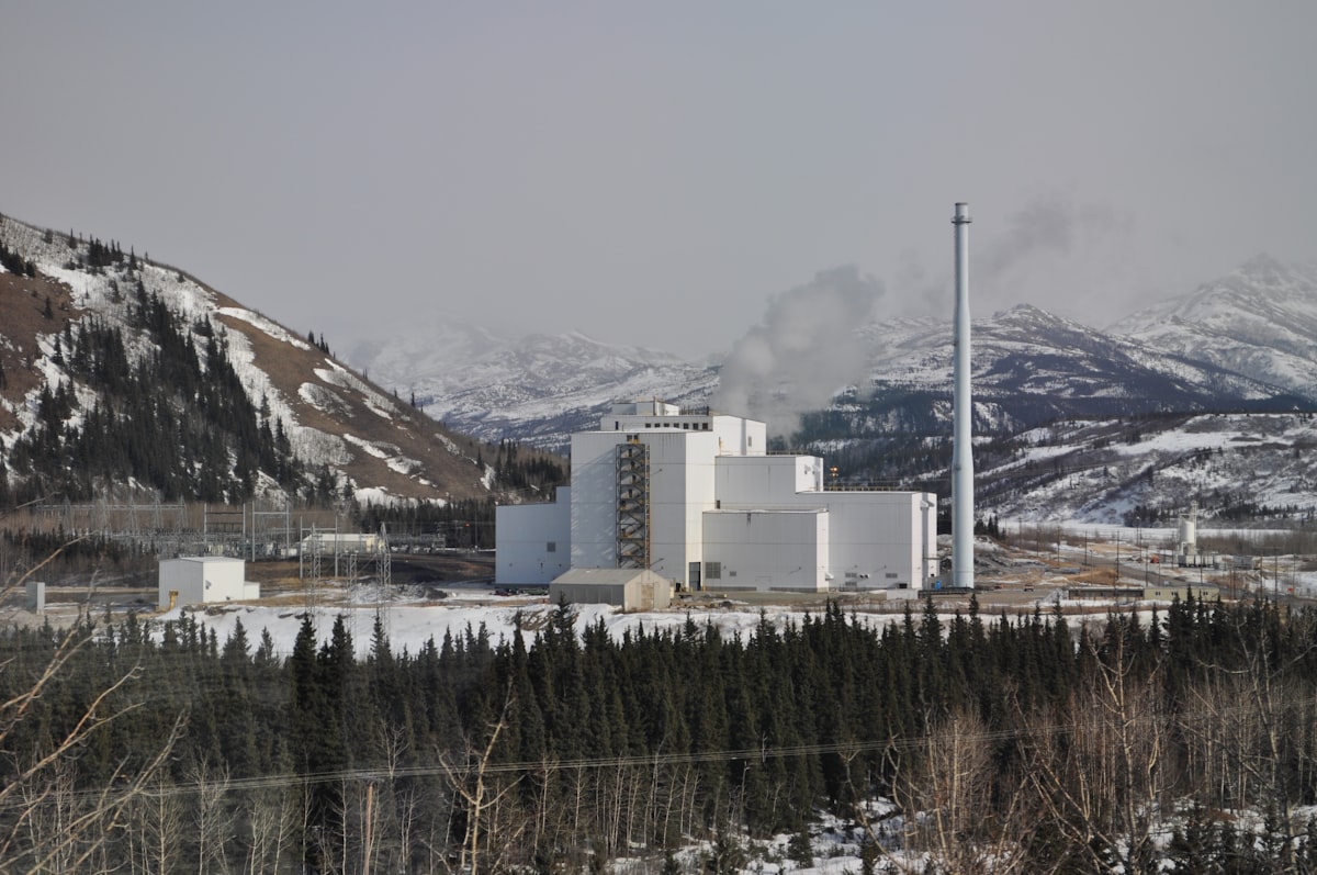 Industrial power plant with smokestacks against a cloudy sky
