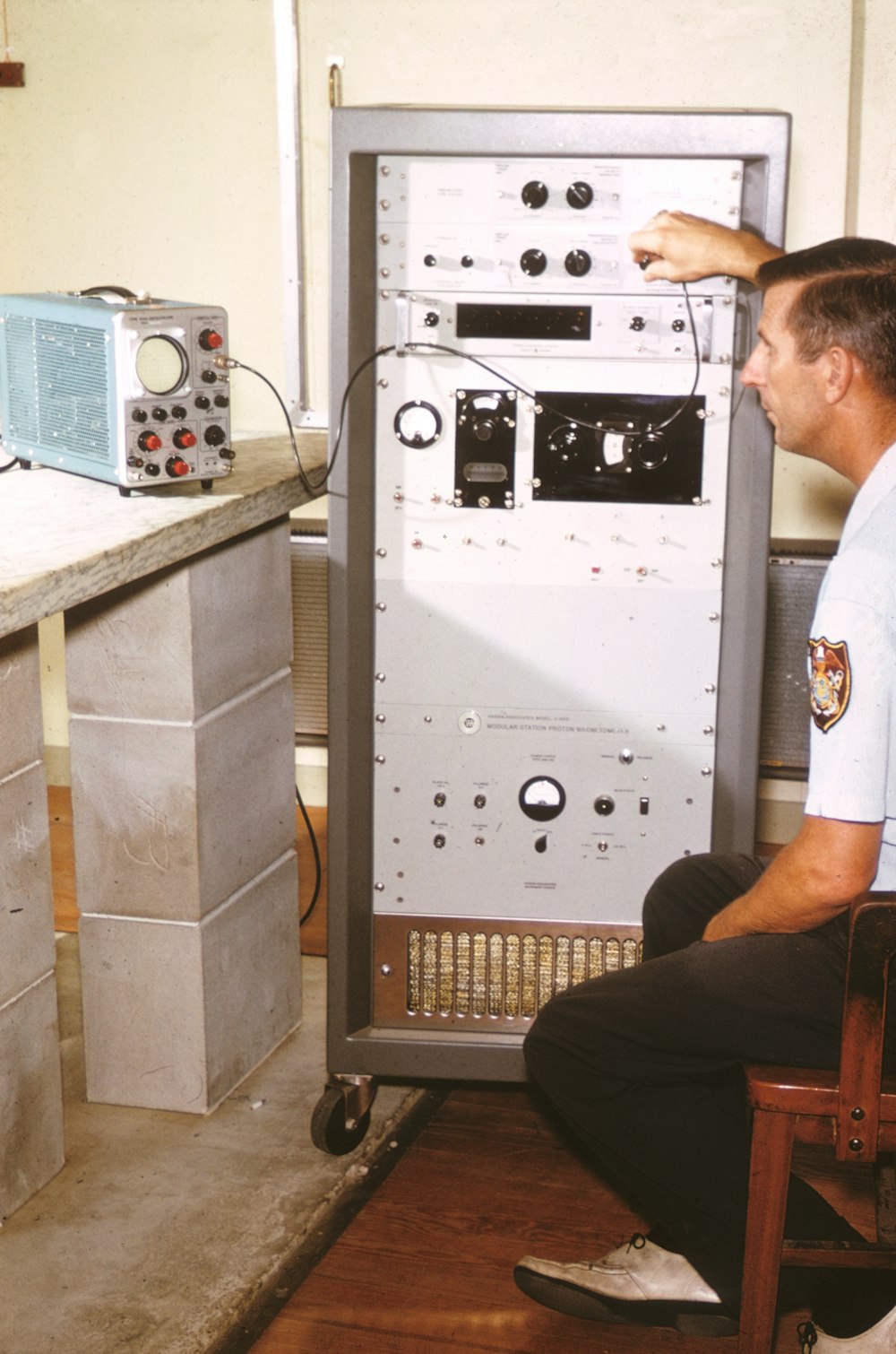 man sitting on chair beside machine