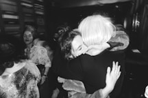 a woman hugging another woman in a crowd