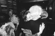 a woman hugging another woman in a crowd