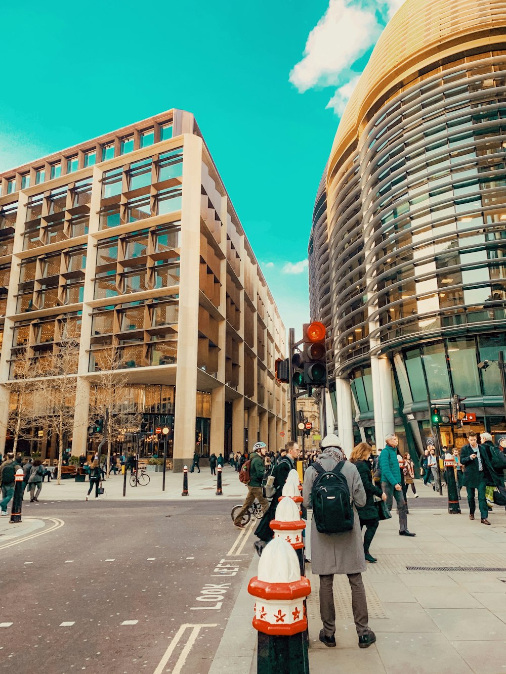 people walking beside road near buildings