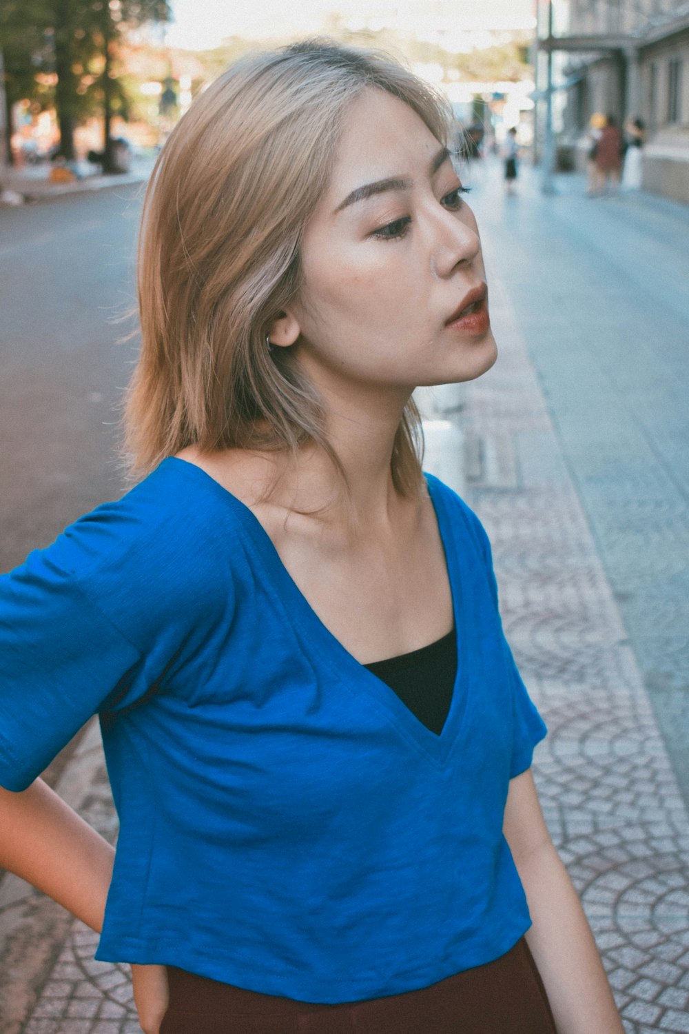 woman standing on street on focus photography