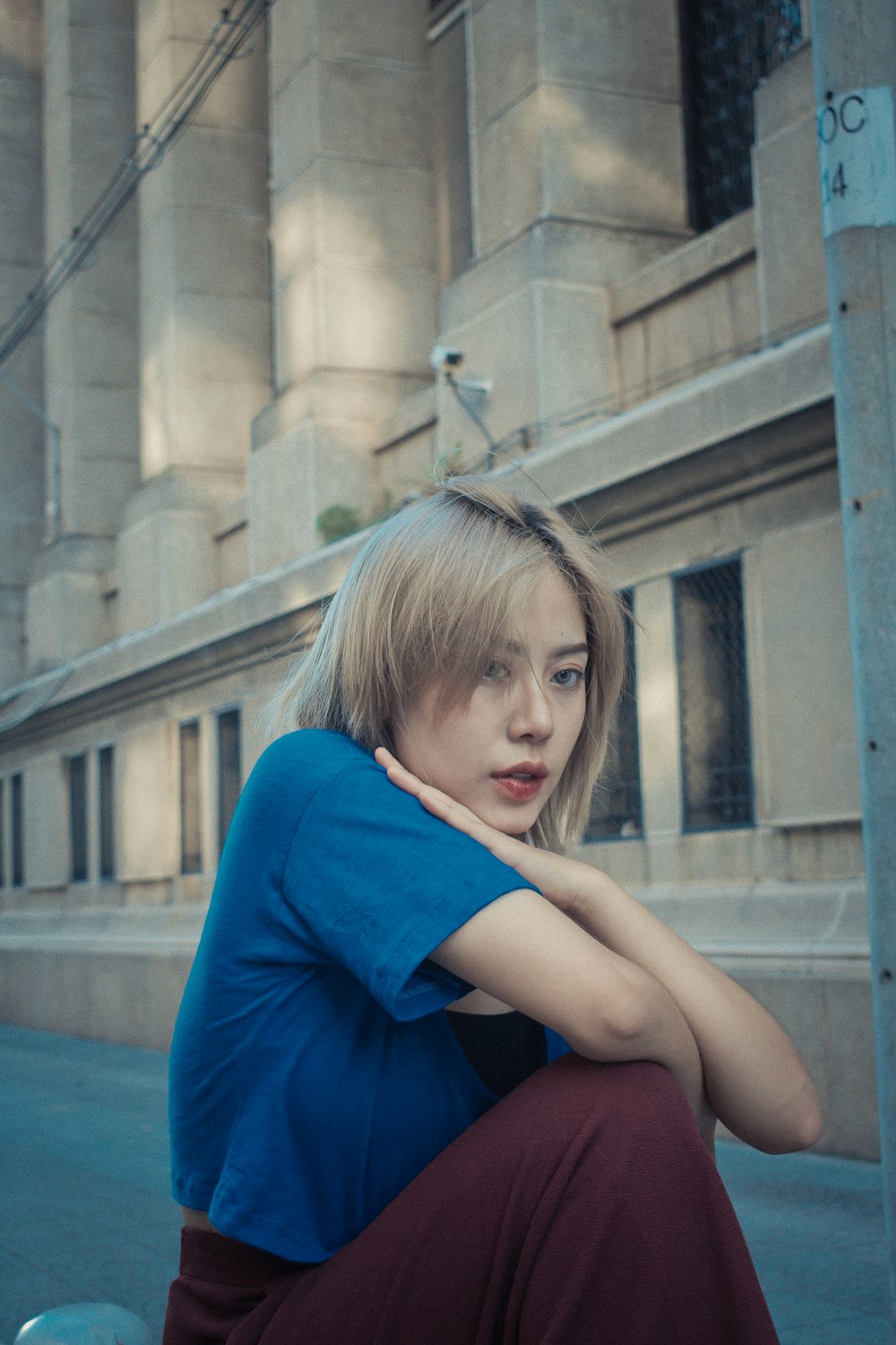 sitting woman on concrete ground