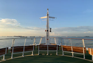 green and brown ship on sea