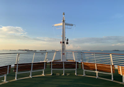 green and brown ship on sea