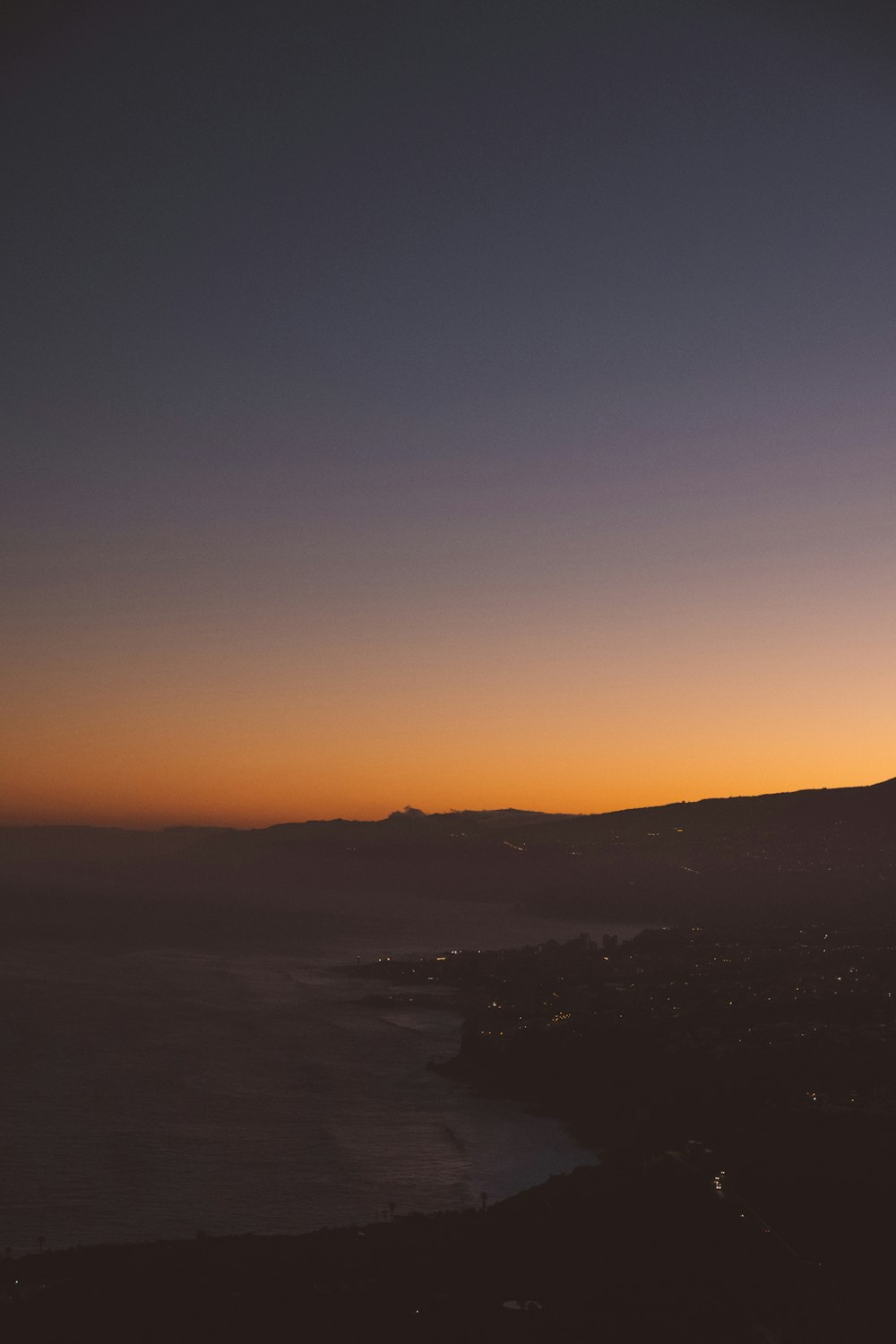 orange sky over beach at dusk