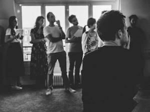 Black and white photo of lawyers discussing a case in a modern office.