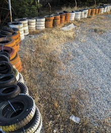 Stacks of various car and truck tires neatly arranged in a well-organized tire shop.