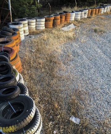 Stacks of bulk tires neatly arranged along the garage wall, ready for delivery.