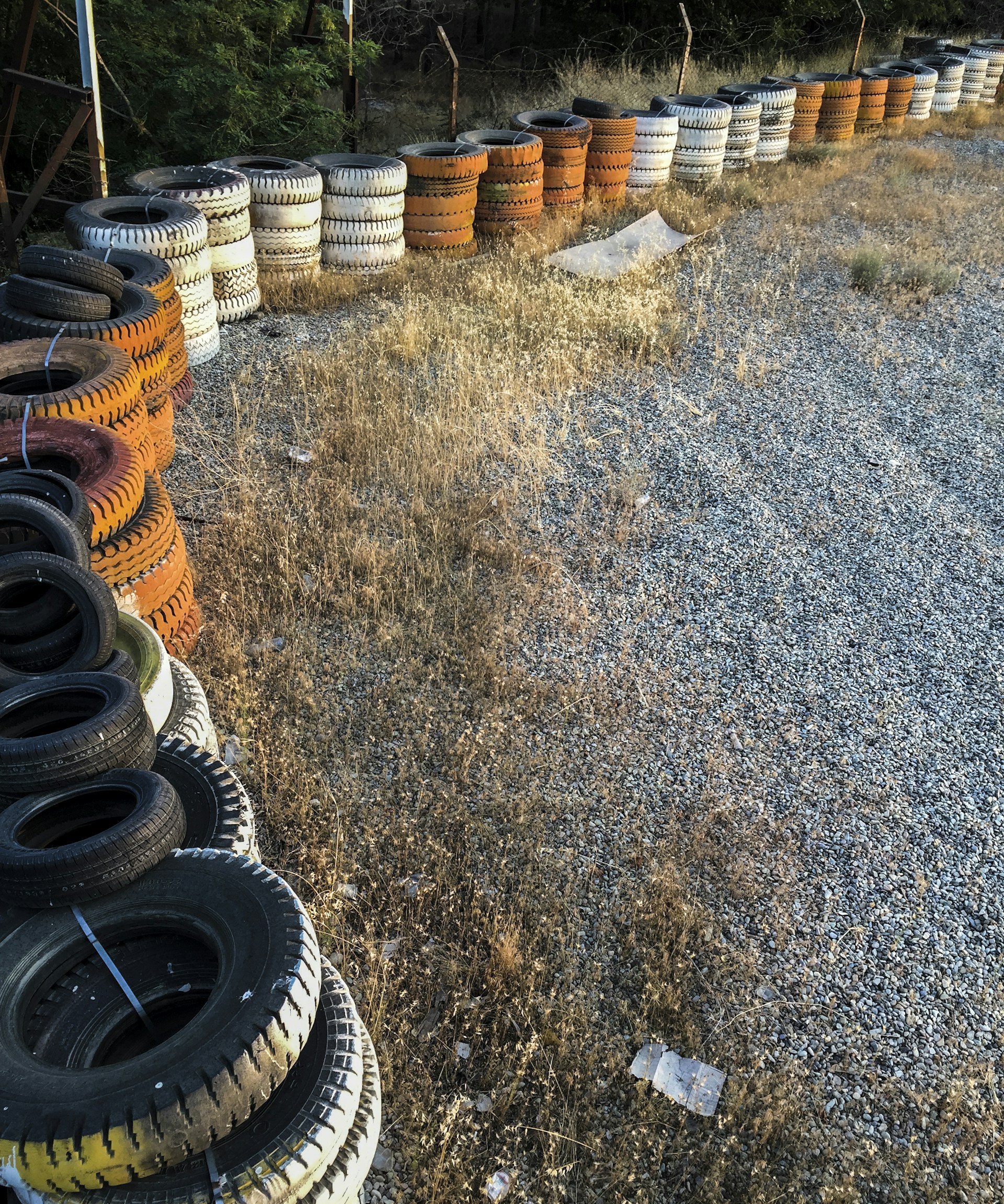 Close-up of organized rows of tire stacks in a spacious storage facility, emphasizing volume and readiness.