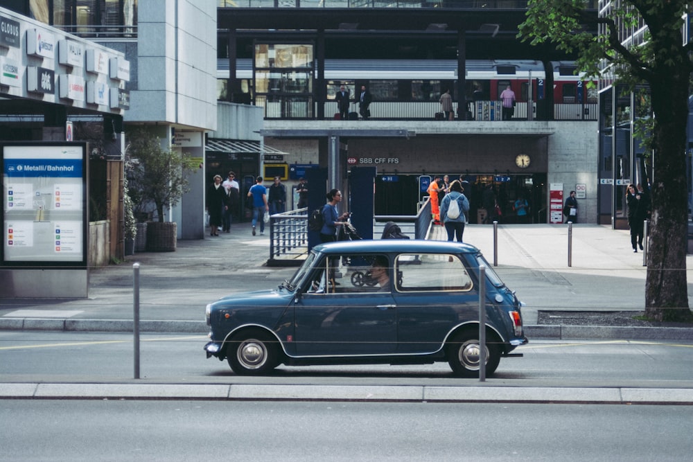 blue car beside trees