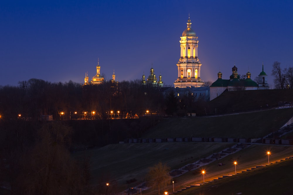 lighted brown concrete buildings at night